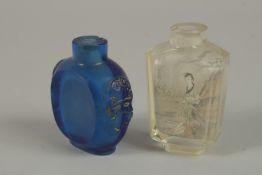 A CHINESE REVERSE GLASS PAINTED SNUFF BOTTLE, together with a blue glass bottle, (2).