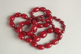 A CHERRY AMBER STYLE BEADED NECKLACE, the beads of graduating sizes.