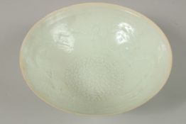 A CHINESE CELADON GLAZE EGGSHELL PORCELAIN DRAGON BOWL, 19.5cm diameter.