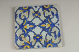 A FINE 18TH-19TH CENTURY PERSIAN GLAZED POTTERY TILE, 20cm square.