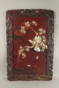 A CHINESE BONE AND MOTHER OF PEARL INLAID LACQUERED HARDWOOD PANEL, depicting birds on a branch with
