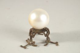 A PEARLESCENT SPHERICAL ORNAMENT ON A BRONZE STAND, the stand formed with tripod chilong legs.