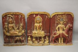 THREE LARGE RELIEF CARVED WOODEN BUDDHISTIC PANELS, each panel gilded and lacquered in red with