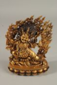 A FINE TIBETAN GILDED ALLOY DEITY, with flaming halo, 18cm high.