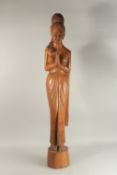 A LARGE BALINESE FLOOR STANDING CARVED WOOD FIGURE, 115cm high.