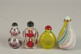 A COLLECTION OF FOUR CHINESE PEKING GLASS SNUFF BOTTLES AND STOPPERS, (4).