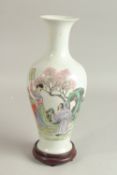 A CHINESE FAMILLE ROSE PORCELAIN VASE, on hardwood stand, the vase painted with figures, the base