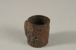 A BRONZE OKIMONO OF A CICADA ON A TREE STUMP.