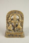 A 19TH CENTURY INDIAN SILVER INLAID GILT BRONZE DEITY, the silver inlays to the eyes and upper arch,