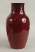 A CHINESE SANG DE BOEUF PORCELAIN VASE, 38.5cm high.