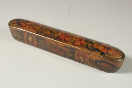 A PERSIAN QAJAR LACQUER PAPIER MACHE PEN BOX, painted with figures and portraits, 22.5cm long.