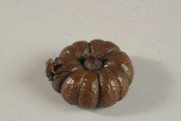 A BRONZE OKIMONO OF A FROG ON A PUMPKIN.