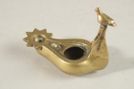 A BRASS OIL LAMP WITH CROSS AND BIRD HANDLE, 10.5cm long.