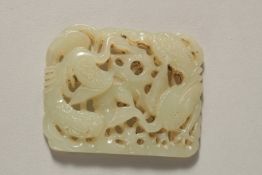 A VERY FINE 19TH CENTURY OR EARLIER CHINESE CARVED JADE PLAQUE, depicting two peacocks, 5.5cm x 4.