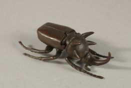 A BRONZE OKIMONO OF A RHINOCEROS BEETLE.