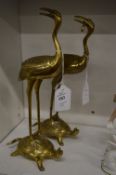 A pair of Chinese style bronze figures of a crane standing on a tortoise.