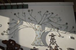 Painted wrought iron wall sculpture as a tree.