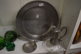 A large pewter charger and other pewter ware.