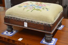 An upholstered footstool.