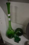 Green glass bottle vase and other items.