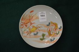 A small Chinese circular dish painted and gilded with crustaceans.