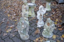 Four various reconstituted stone garden figural ornaments (one decapitated).
