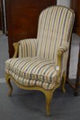 A small French style painted and upholstered armchair.