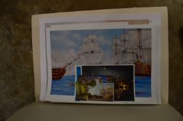 A folder of unframed prints.