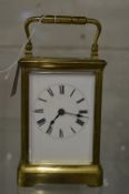 Large brass carriage clock with leather travelling case and key.