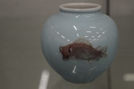 A small Chinese pale blue ground vase painted with fish.