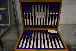 A good cased set of twelve silver and mother of pearl handled dessert knives and forks.