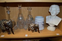 A pair of cut glass decanters, decorative model elephants and other items.