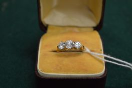 A 9ct gold and diamond three stone ring.