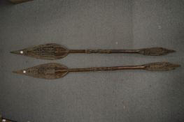A pair of African carved wood spear shaped paddles.