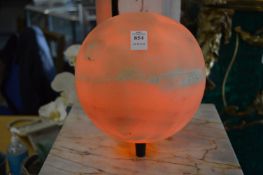 An alabaster globe shaped lamp.