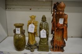 A group of three Chinese carved soap stone figures and a carved soap stone vase.