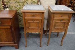 A pair of 19th century French walnut and marble top pot cupboards.