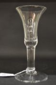 A plain Georgian wine glass with an inverted bell shaped bowl.