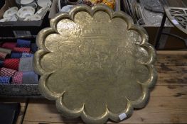 Three Eastern brass chargers.