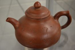 A Chinese Yixing teapot.