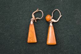 A pair of silver and amber earrings.