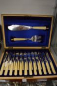A cased set of twelve fish knives and forks with servers.