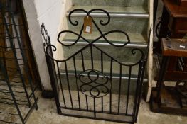 A folding wrought iron spark guard.
