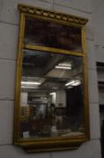 A decorative gilt framed mirror.