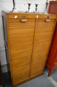 An oak twin section filing unit with tambour doors.