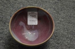 A small Chinese bowl with purple splash decoration.