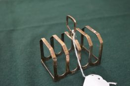 A small silver toast rack.