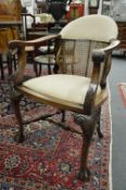 A good pair of carved walnut open armchairs with upholstered and cane work backs and seats.