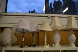 Two pairs of table lamps and three other lamps.