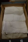 A box of embroidered tablecloths.